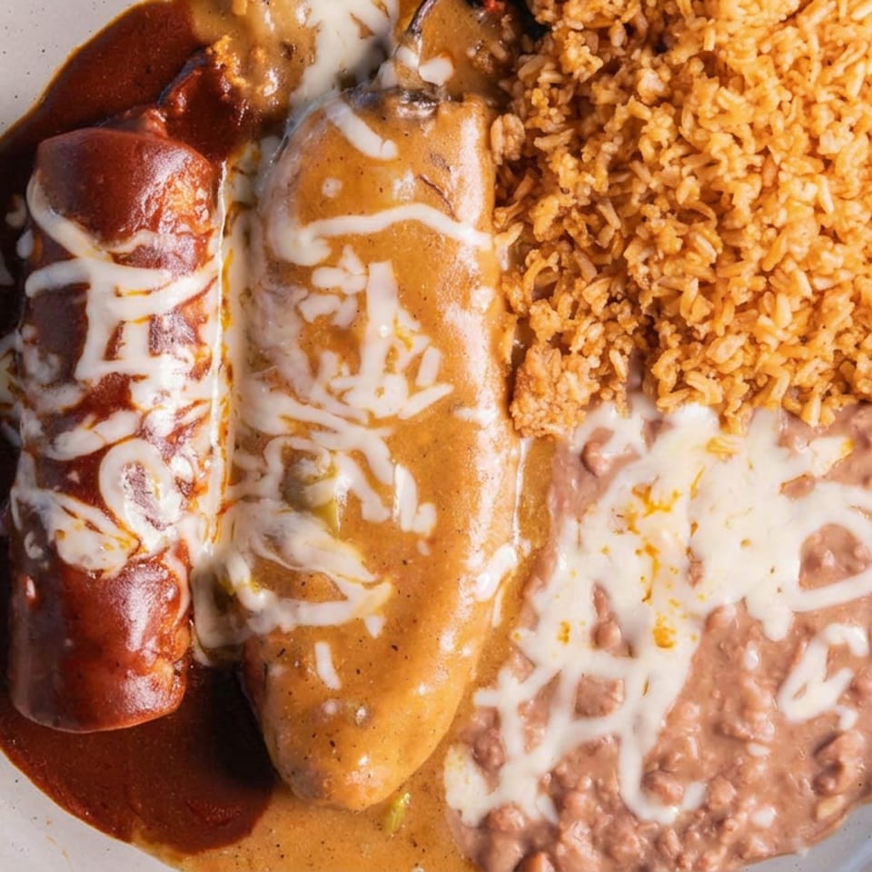 A plate of Mexican food with an enchilada, chile relleno, rice, and refried beans.
